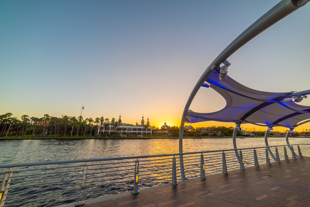 Tampa Riverwalk under a clear sky at sunset